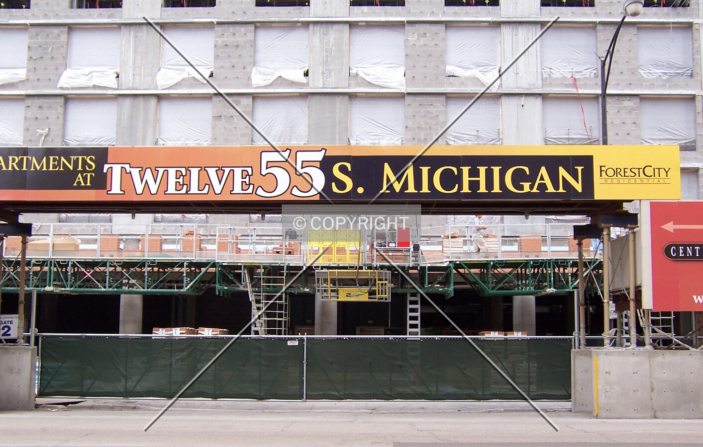 View of west side of the base along Michigan Avenue showing brick layers beginning to apply the masonry façade of the base at the second floor