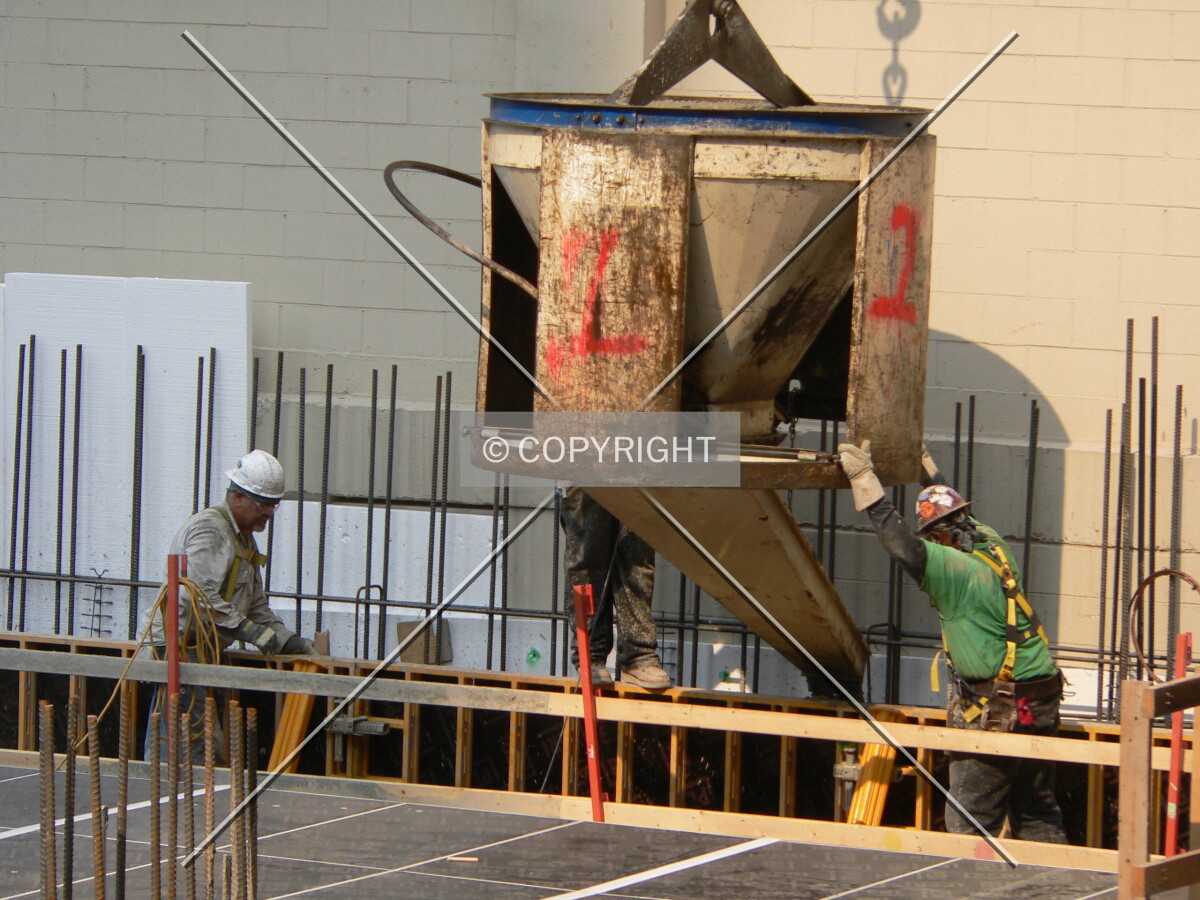 Construction workers pouring concrete
