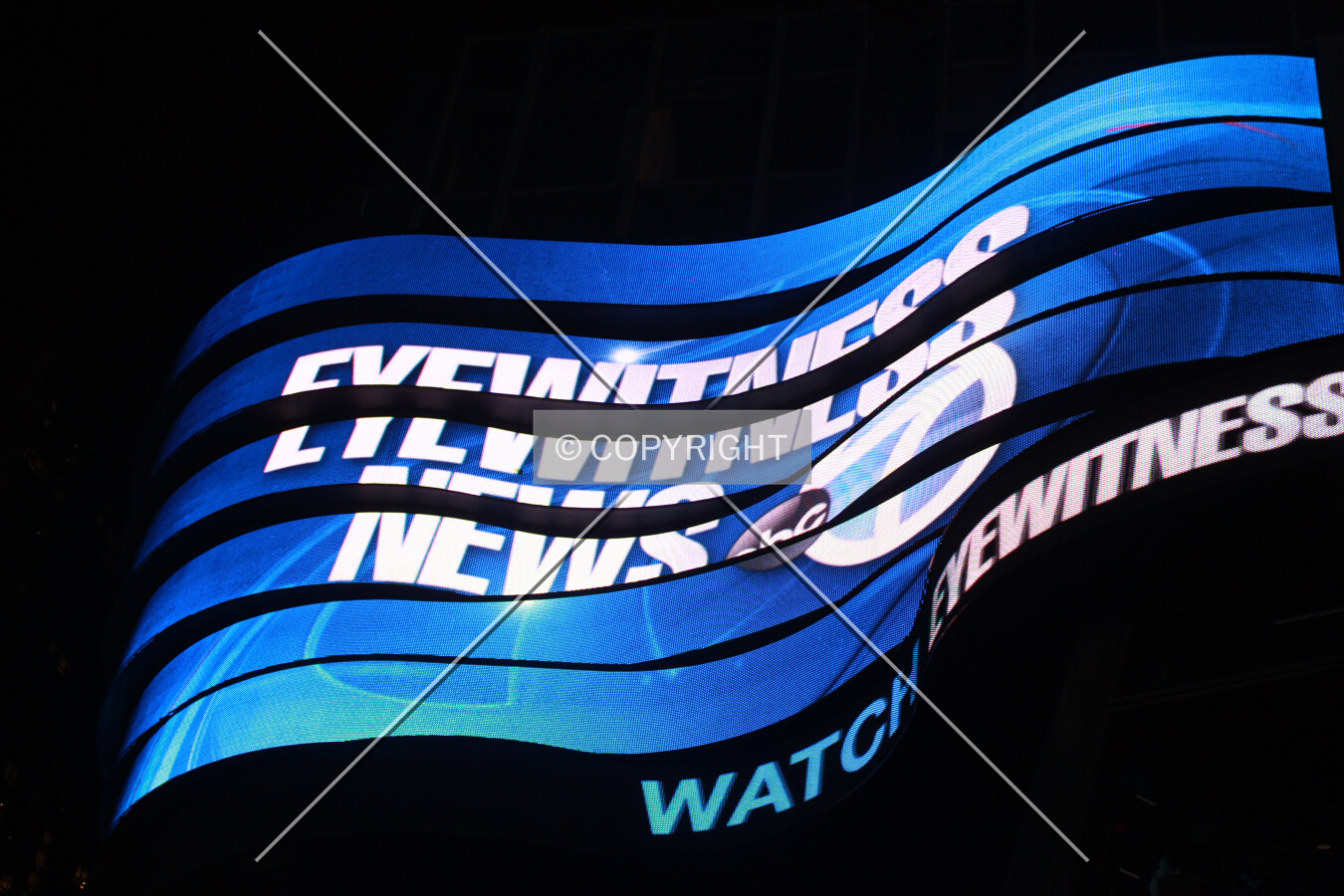 Looking up at a sign on the northwest corner at night; April 26, 2014