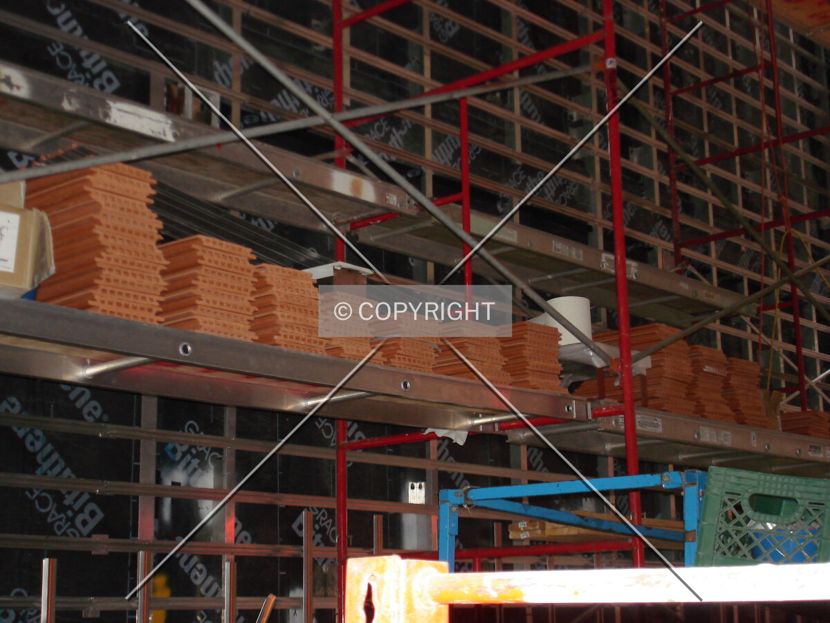 Terracotta bricks being installed in the mid-block public area