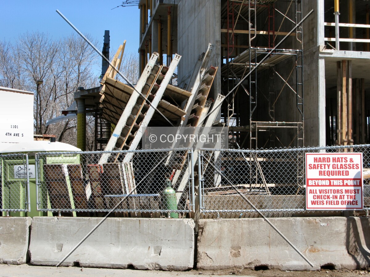 Unused formwork propped against the base
