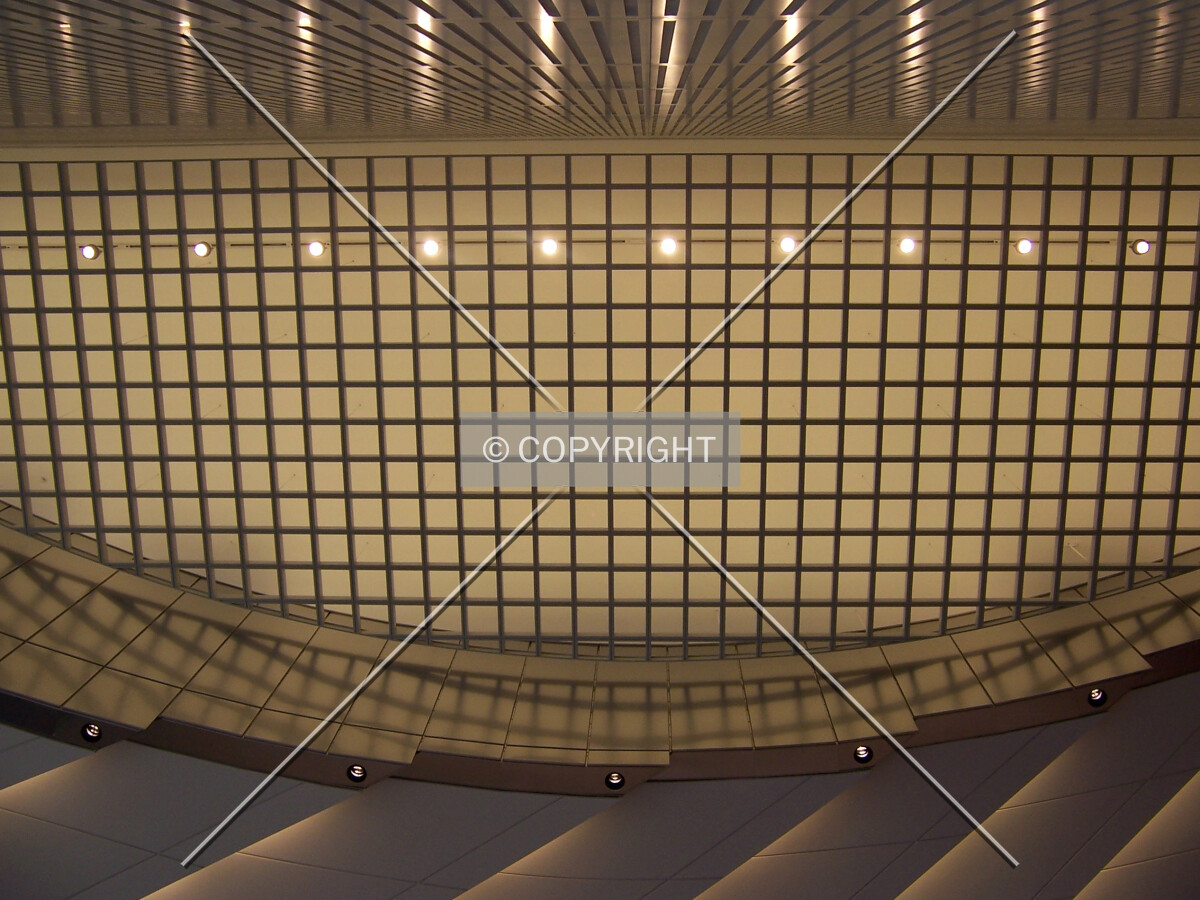 Looking up at the lobby ceiling next to a bank of elevators