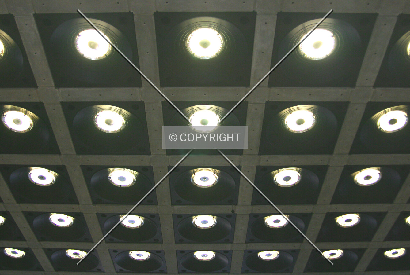 Spotlamp array set into the bare concrete ceiling