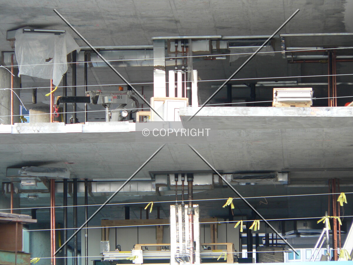 Water pipes and ventilation ducts being instaalled in the lower levels