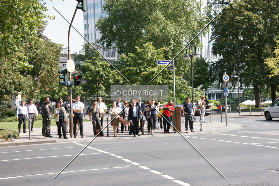 A crowd of people is waiting at traffic lights