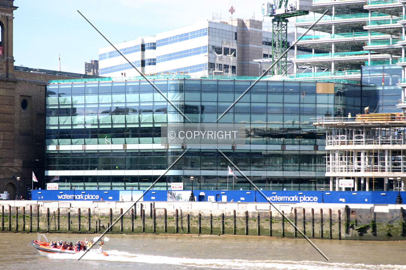 View north across the Thames showing the completed façade installation to the south side of the west wing
