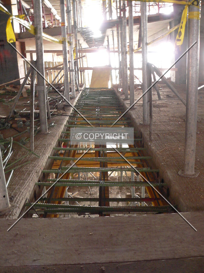 View of several gaps between two slabs of concrete on the ramp within the parking structure