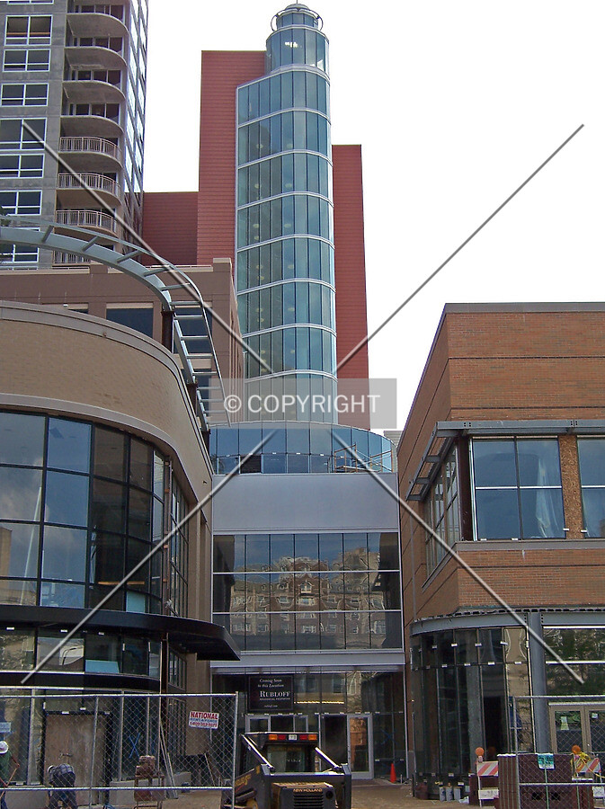 Retail shops, and a stairway-elevator tower in the middle of the block along Sherman Avenue