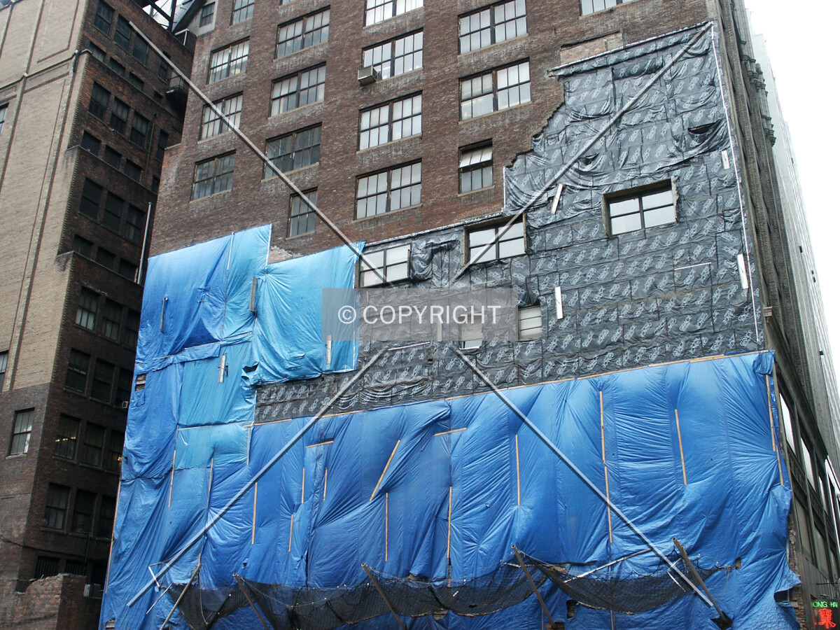 Protective wrapping on a neighboring building