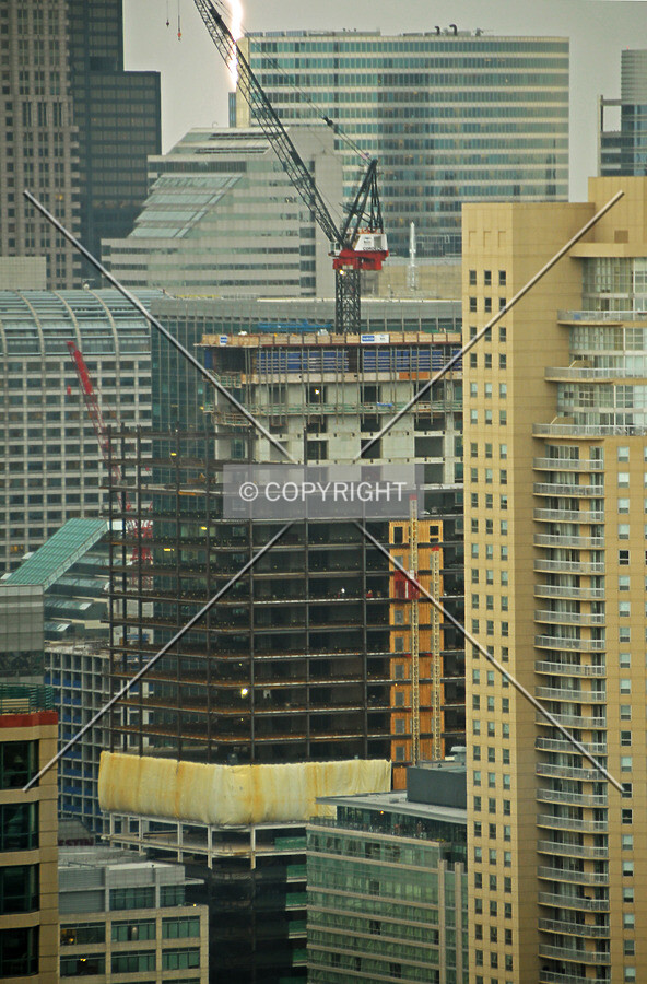 Looking southwest from the 44th floor of the John Hancock Center during a summer thunderstorm. A lightning bolt striking a high-rise in the background is also visible