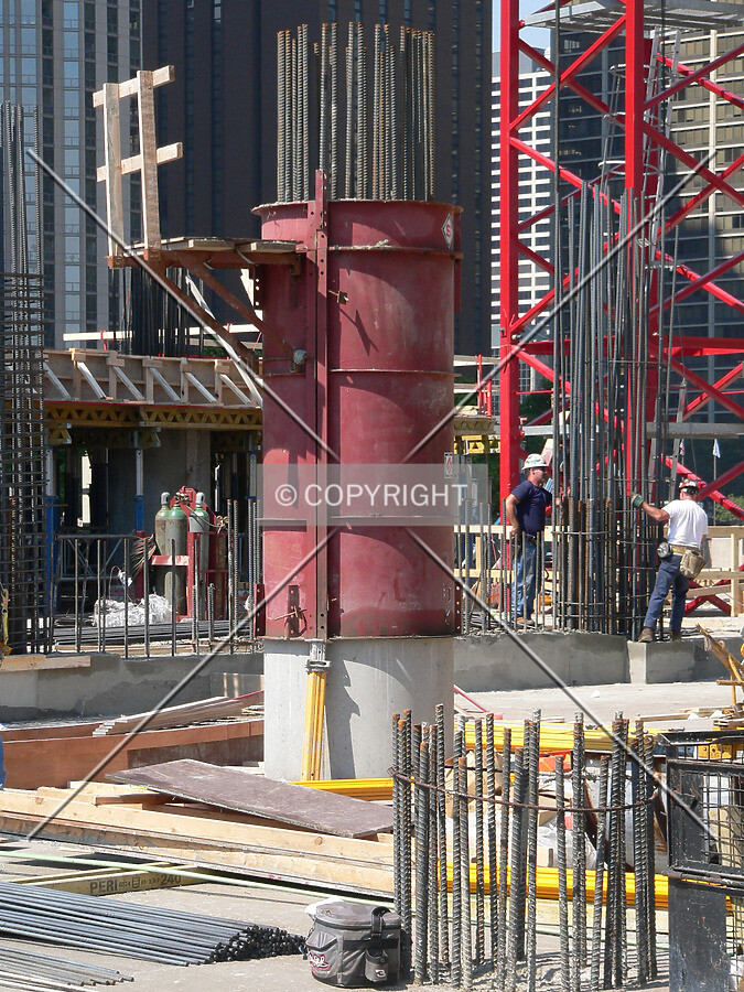 A concrete column with metal formwork and steel rebar