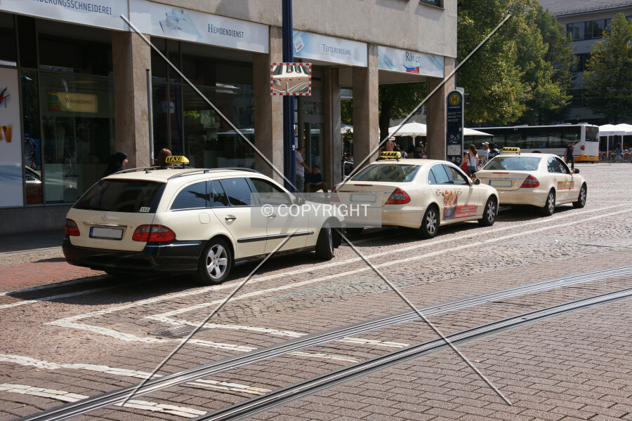 Three taxis waiting for guests