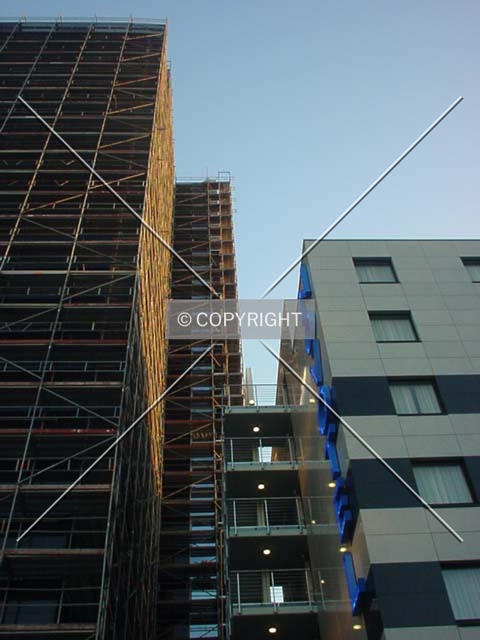 Between the tower and nearby building