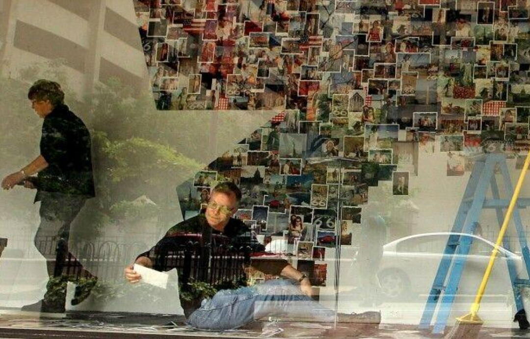 Macy's employees work on a window display on the Olive Street side ; May 20, 2013