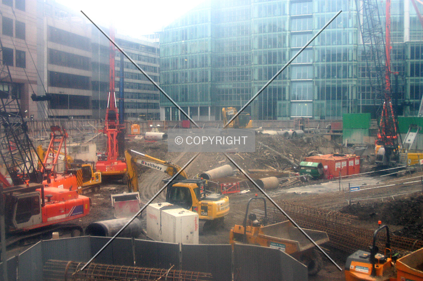 View south from Chiswell Street through a filthy perspex observation window in the site's hoarding