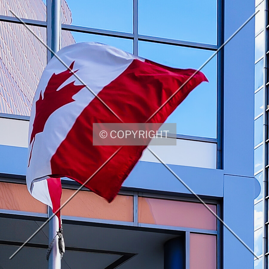 A Canadian flag flying above the entrance; July 4, 2021