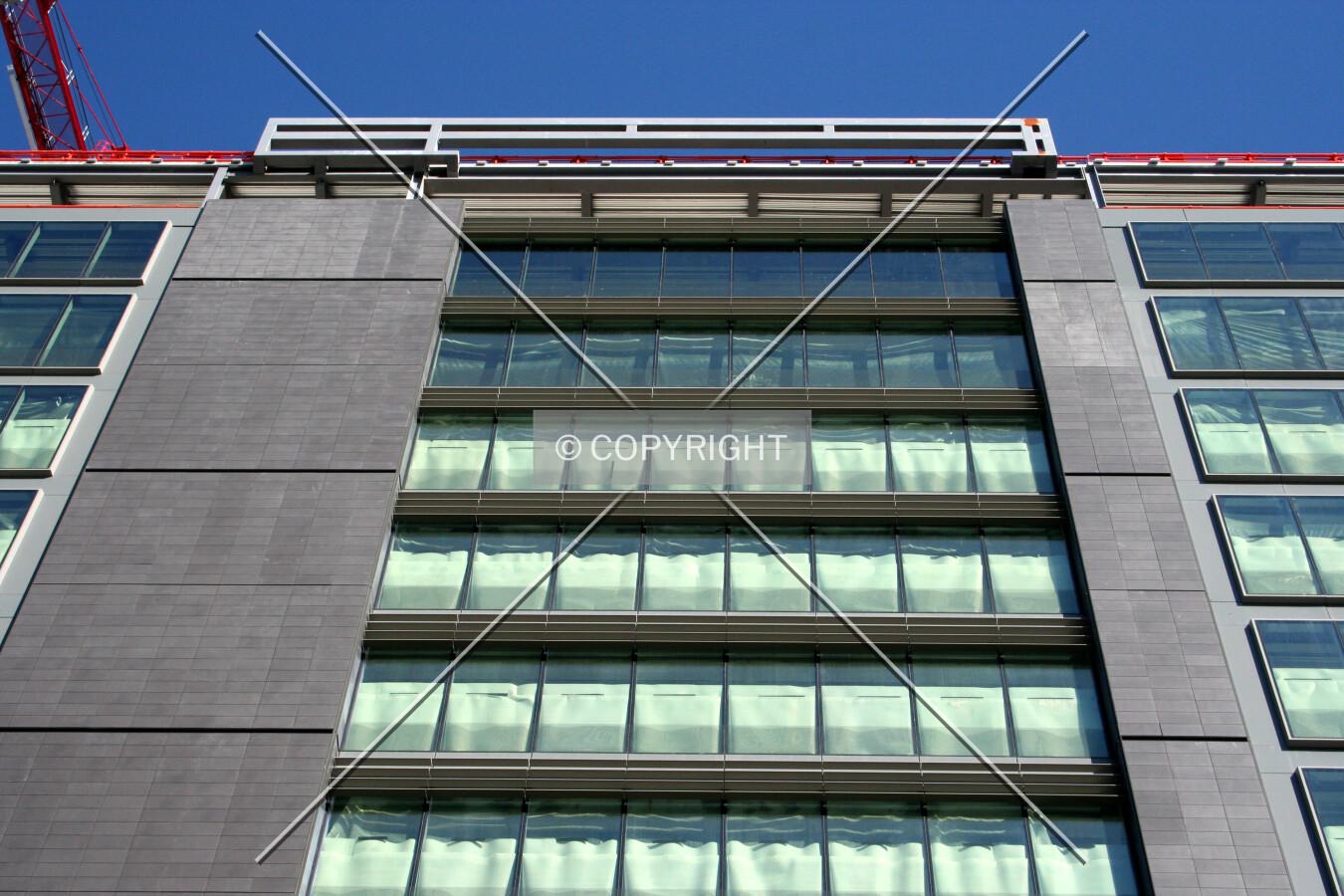 Looking up from street level at the facade progress