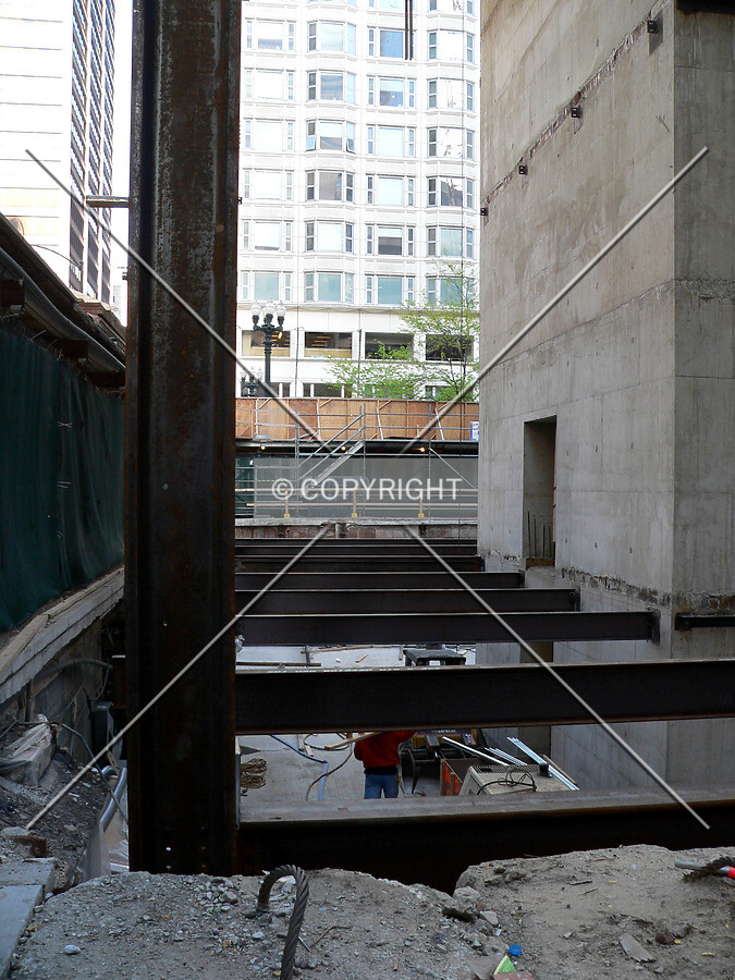 Vertical and horizontal steel beams being installed