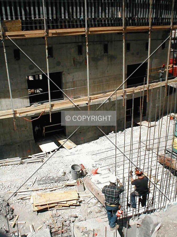 Construction workers installing rebar
