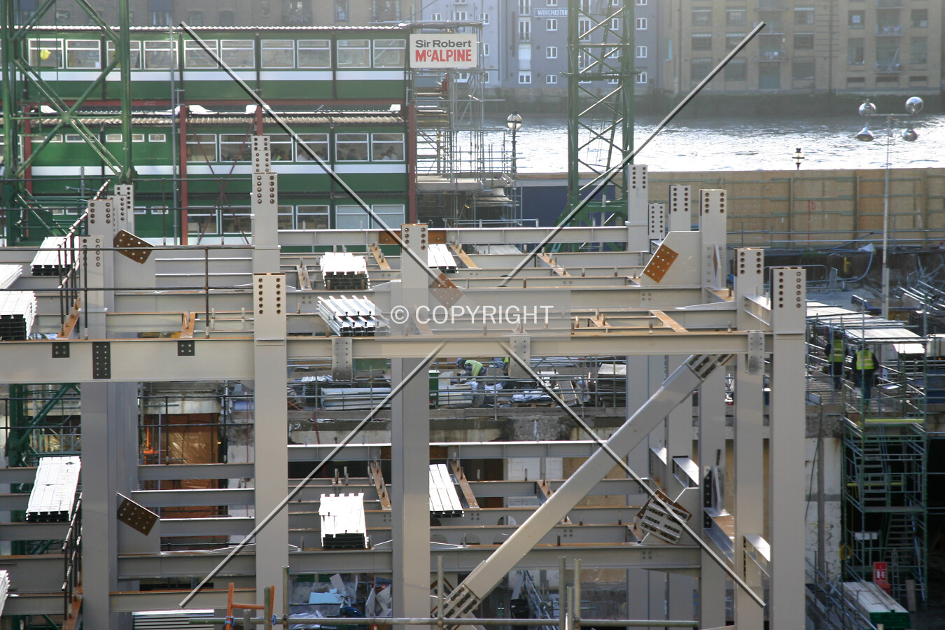 Elevated view south across Upper Thames Street of the steel frame