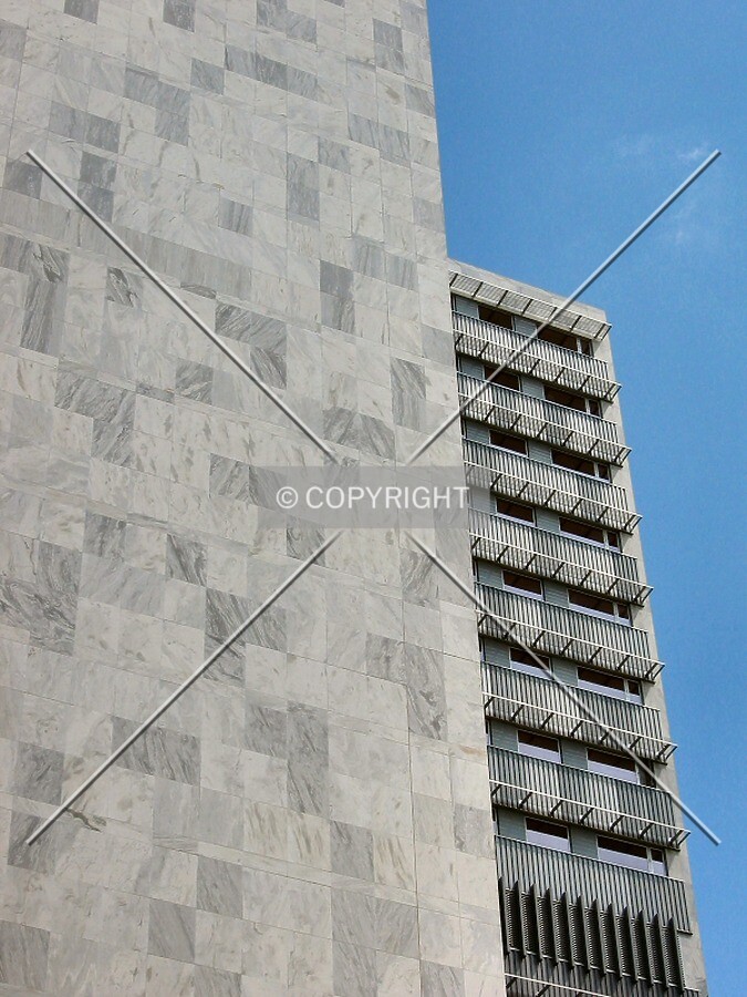 Looking up from 2nd Street SW, marble panels and shaded windows