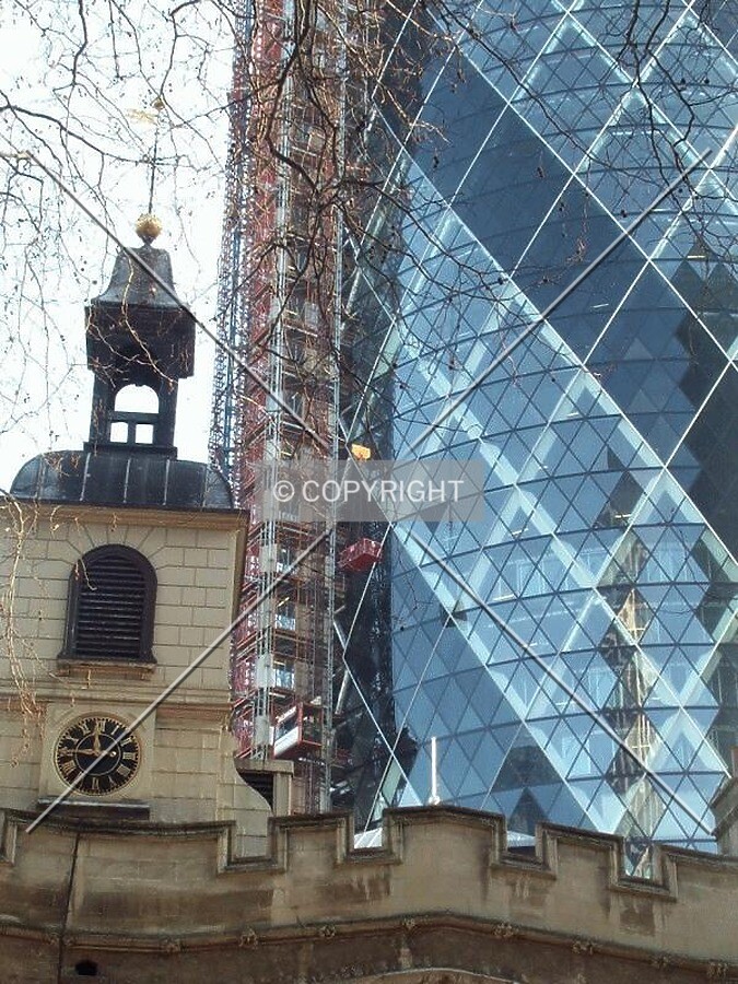 Old meets new as the 21st century skyscrapers rises behind a 13th century church (24/01/03)
