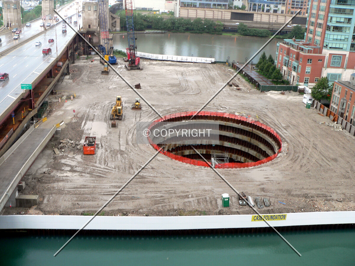View of the site from a nearby parking garage with a rising river and slip