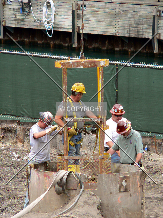 Lowering a worker into an access shaft to a freight tunnel that runs under the site