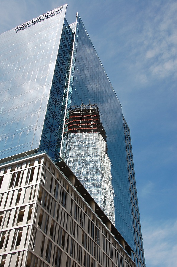 Construction reflected in the glass facade
