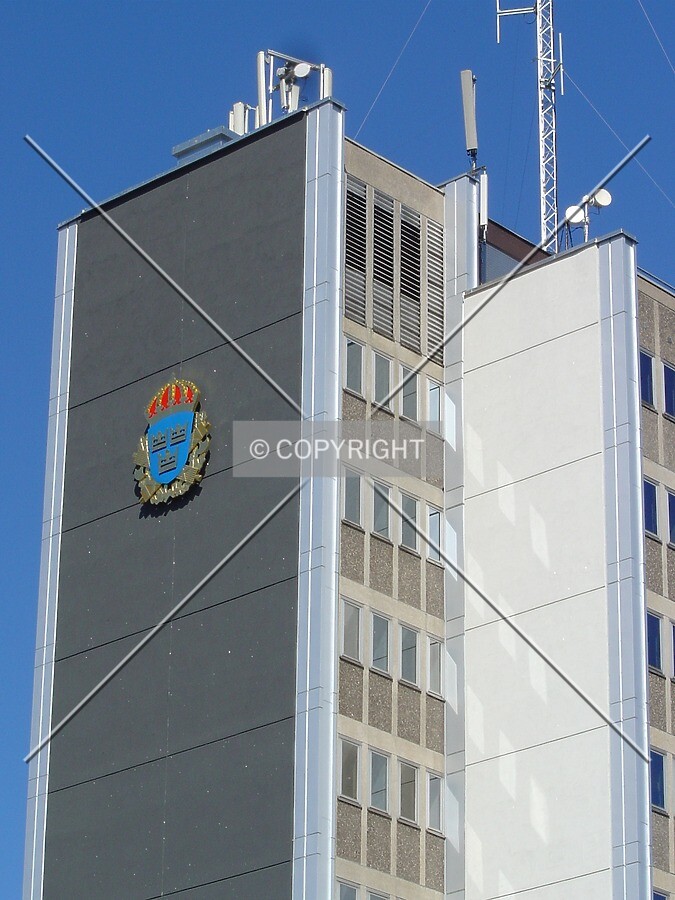 Top of the building with the Swedish police logo on the southeast facade