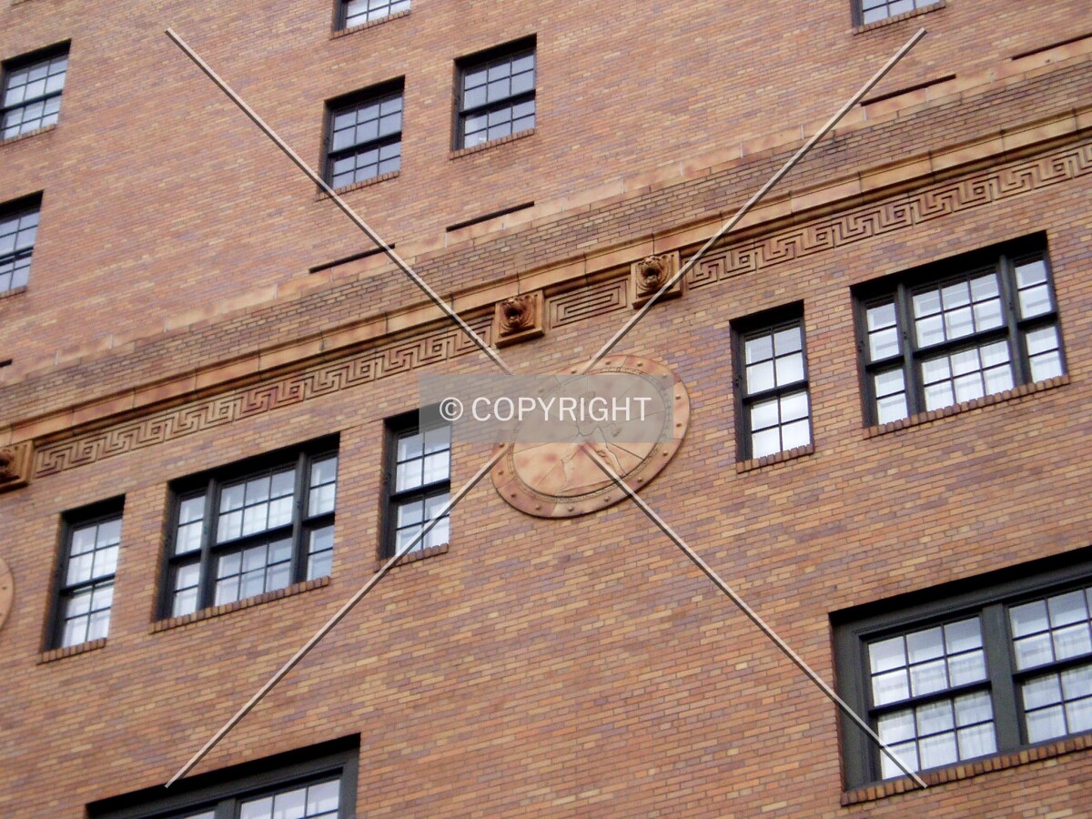 The brick facade pattern and a sculptured detail