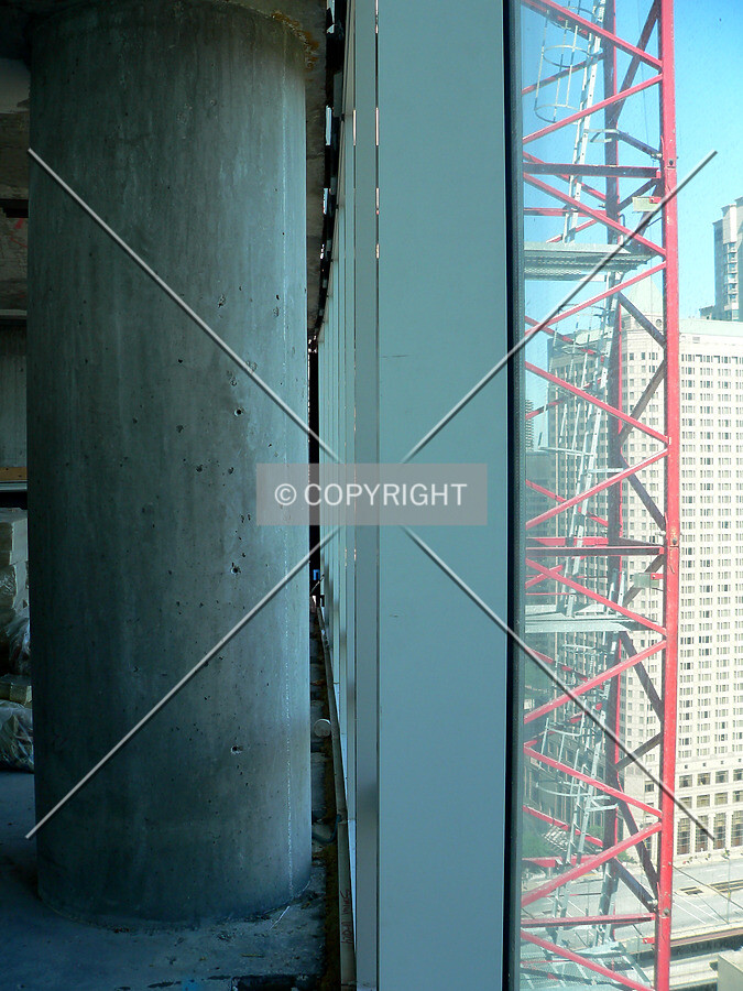 A column, window mullion and tower crane visible