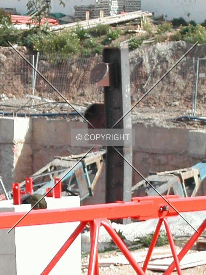 Close view of one pillar and a reinforced concrete wall