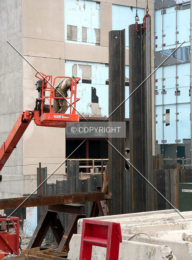 Workers driving steel sheeting into place