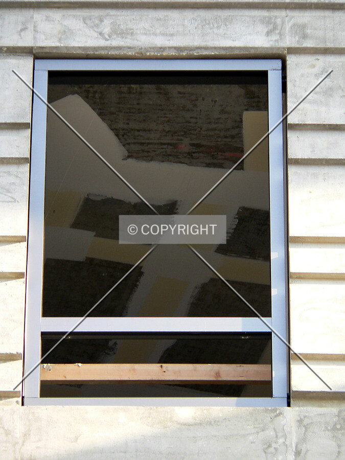 Window installation occuring on the northern side of the building