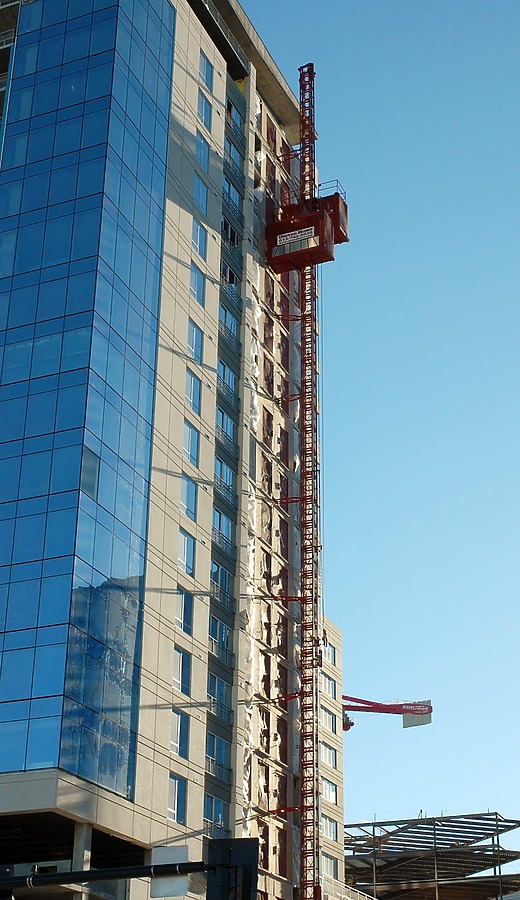 A construction elevator in the late afternoon sky
