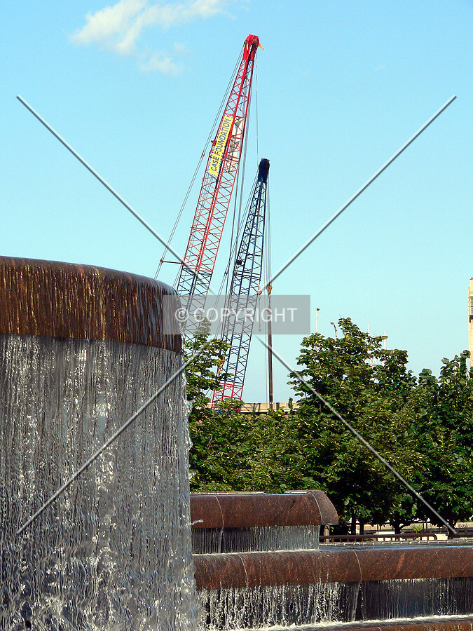 Cranes at the construction site as seen from Centennial Fountain