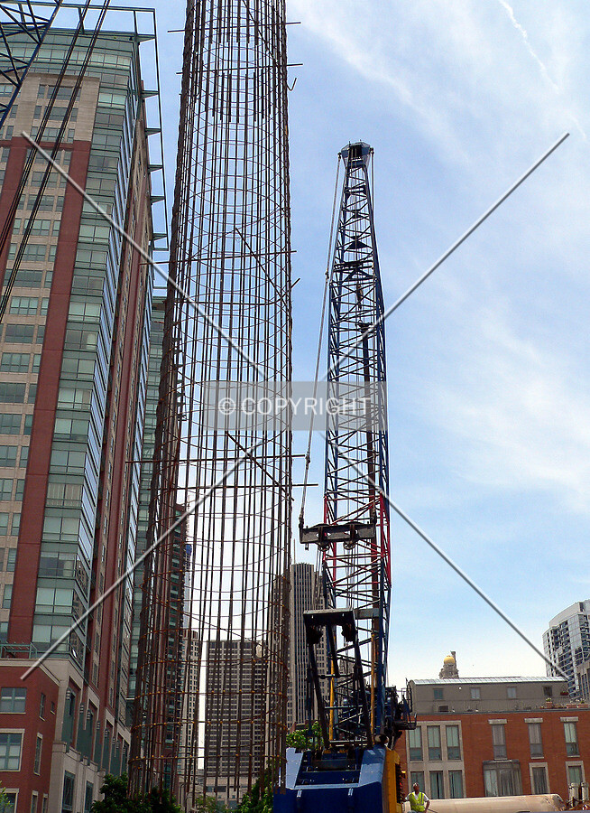 Preparing to lower a caisson rebar cage into position