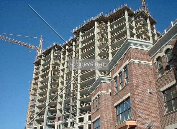Tower rising over townhomes, from Grant Street