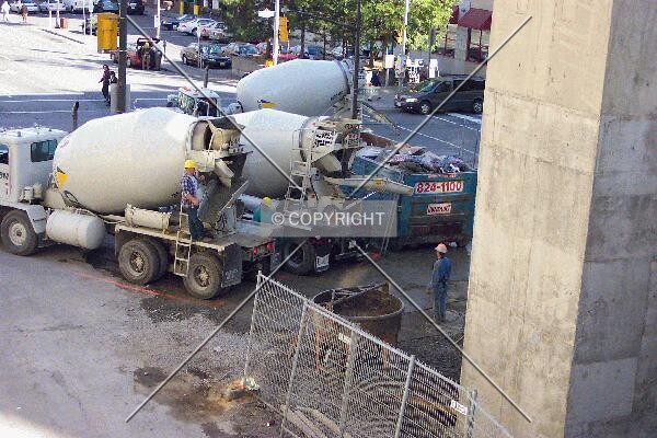 Concrete mixers waiting in the parking garage entrance