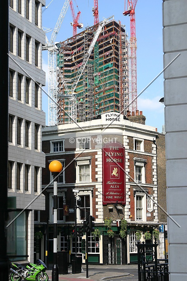 Rising above a 19th century pub from Finsbury Square