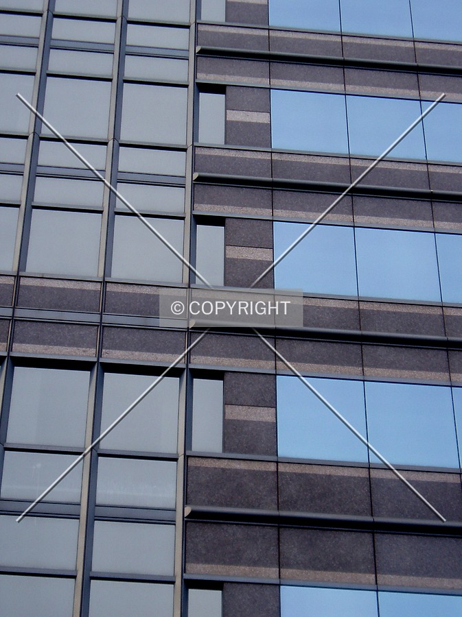 Glass and stone make up the facade a few floors above the south side of the base