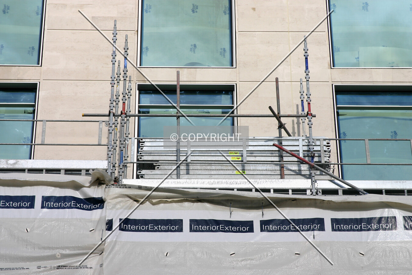 Scaffold and tarpaulins on the south side