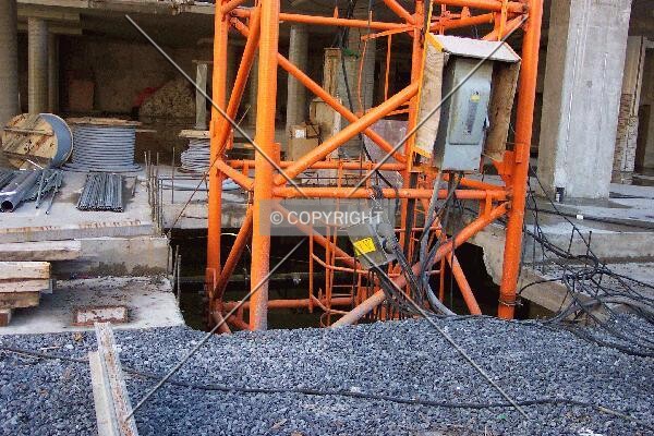 Looking at the base of the crane and the basement floor to which it is anchored
