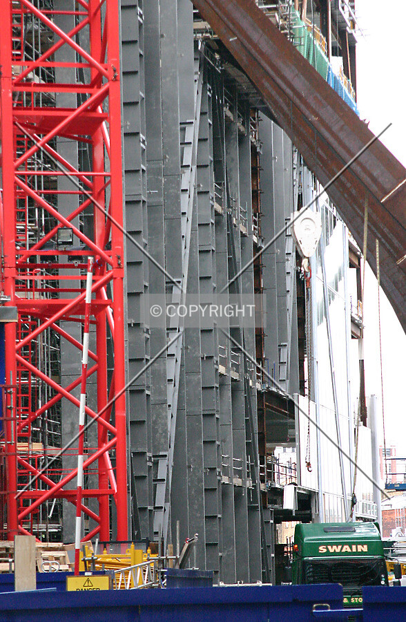 View of the east side and A-frame with partially installed façade panels to the rear