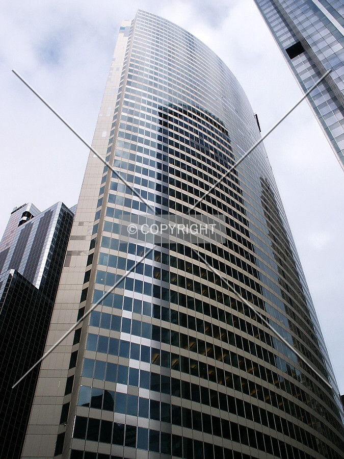 Looking up from the southwest, with white wrapping on part of the facade