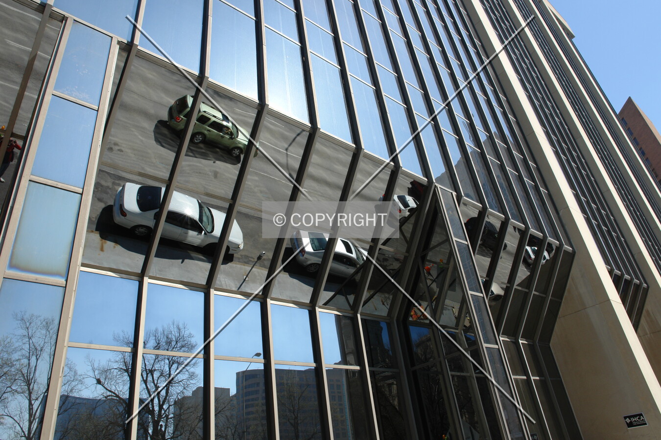 Cars reflecting in the building facade