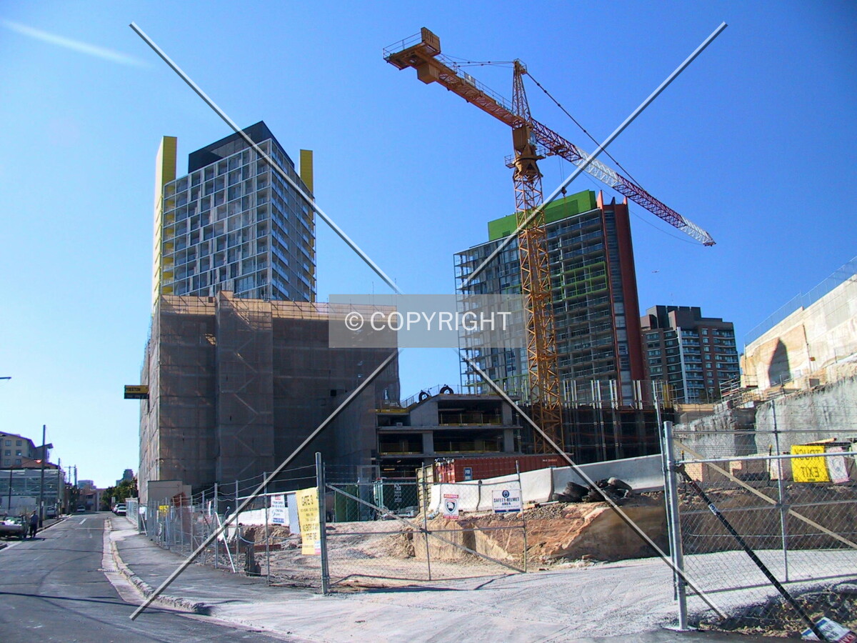 Knox Apartments to the left behind scaffolding and Stonecutters Tower rising where the crane is
