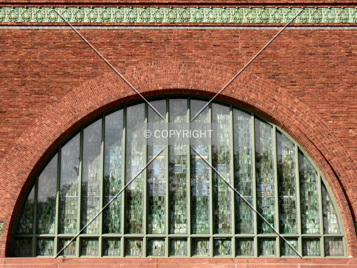 Dramatic window and terra cotta beltcourse from the south