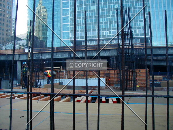 Ground level with the workers and the rebar